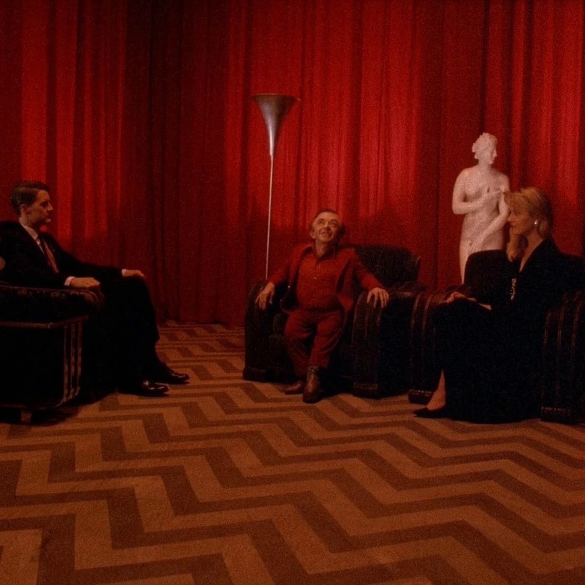 Twin Peaks: the Red Room, chevron floor, red curtains and the group seated